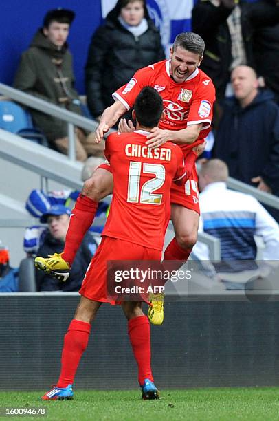 Dons Ryan Lowe celebrates scoring with Adam Chicksen against Queens Park Rangers during the FA Cup fourth round football match between QPR and MK...