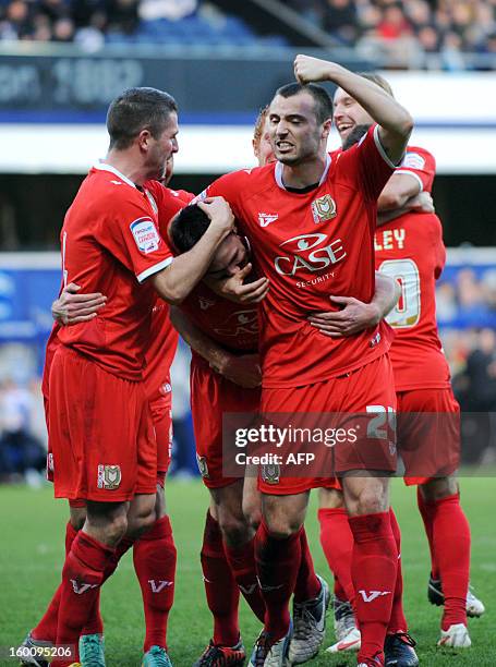 Dons' Darren Potter celebrates with teammates scoring a goal against Queens Park Rangers during the FA Cup fourth round football match between QPR...