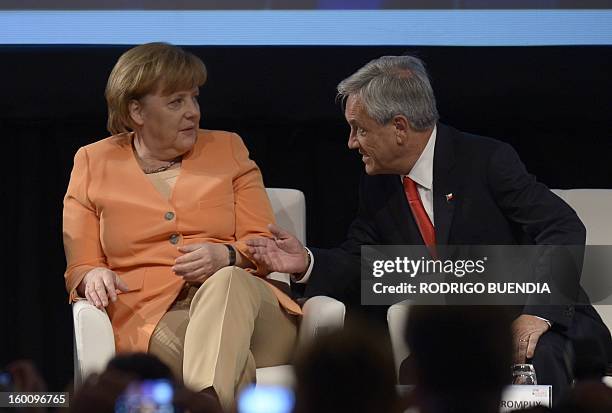 German Chancellor Angela Merkel and Chilean President Sebastian Pinera chat during the IV Business Meeting being held in Santiago in the framework of...