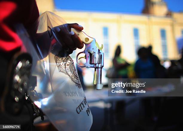 Handgun is tagged and processed as the City of Miami police take in weapons during a gun buy back event on January 26, 2013 in Miami, Florida. The...