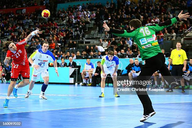 Ivan Cupic of Croatia scores a goal Primoz Prost of Slovenia during the Men's Handball World Championship 2013 third place match between Slovenia and...