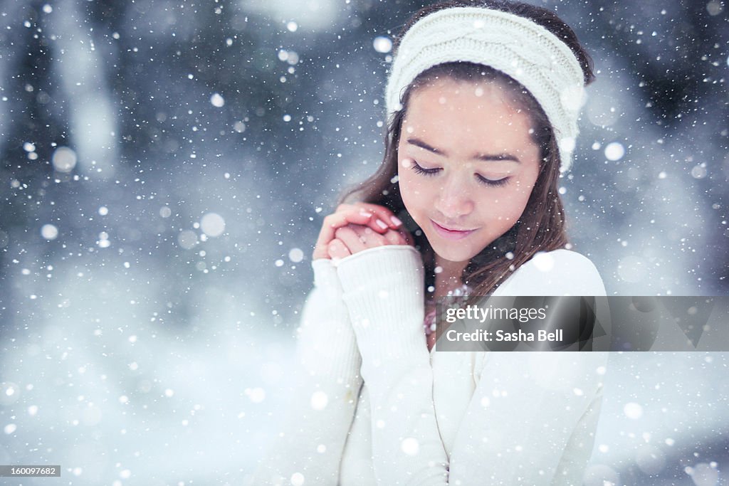 Girl in the snow wearing cream headband
