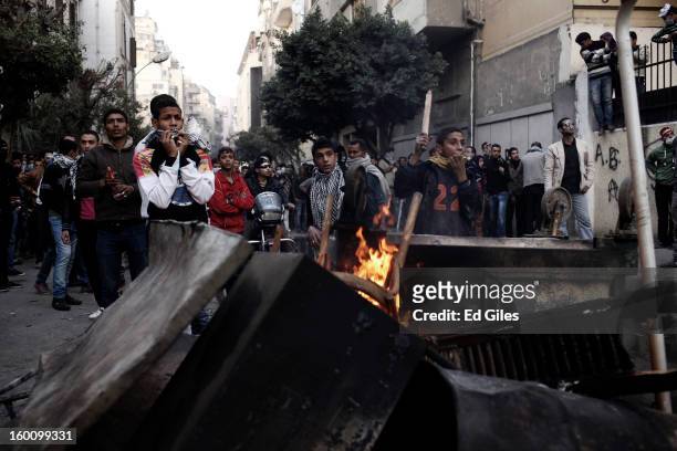Group of Egyptian protesters take cover from nearby Egyptian riot police during a protest following the announcement of the death penalty for 21...