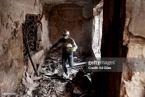 An Egyptian protester walks through a damaged school building during a demonstration following the announcement of the death penalty for 21 suspects...