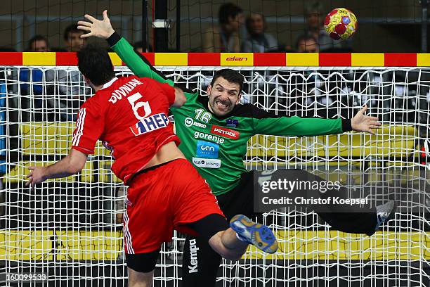 Domagoj Duvnjak of Croatia scores a goal Primoz Prost of Slovenia during the Men's Handball World Championship 2013 third place match between...