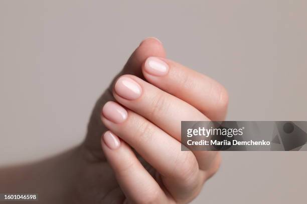 hand with beautiful manicure - pink gel nails - nagelhaut stock-fotos und bilder
