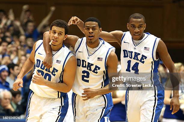 Seth Curry of the Duke Blue Devils and teammates Quinn Cook and Rasheed Sulaimon react after a play against the Maryland Terrapins during their game...