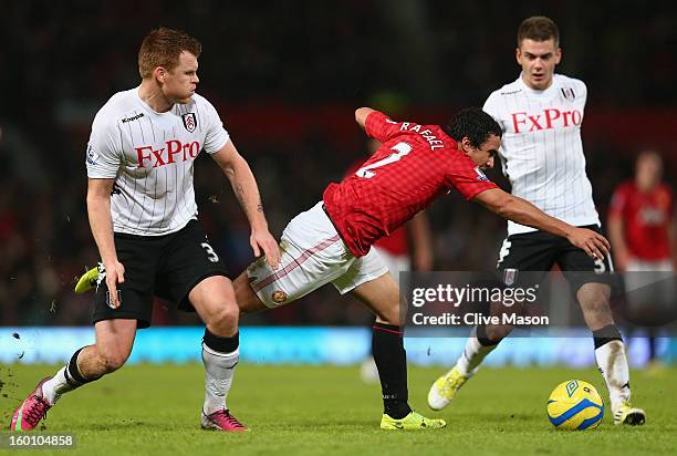 John Arne Riise of Fulham tangles with Rafael of Manchester United during the FA Cup with Budweiser Fourth Round match between Manchester United and...