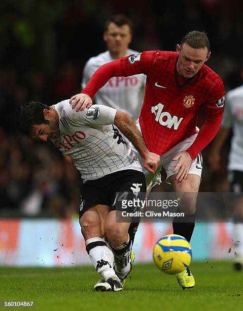 Giorgos Karagounis of Fulham battles for the ball with Wayne Rooney of Manchester United during the FA Cup with Budweiser Fourth Round match between...