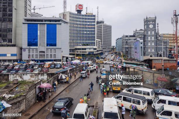 Taxi vans and street traders line a road in the Central Business District of Lagos, Nigeria, on Monday, Aug. 14, 2023. Nigerian President Bola Tinubu...