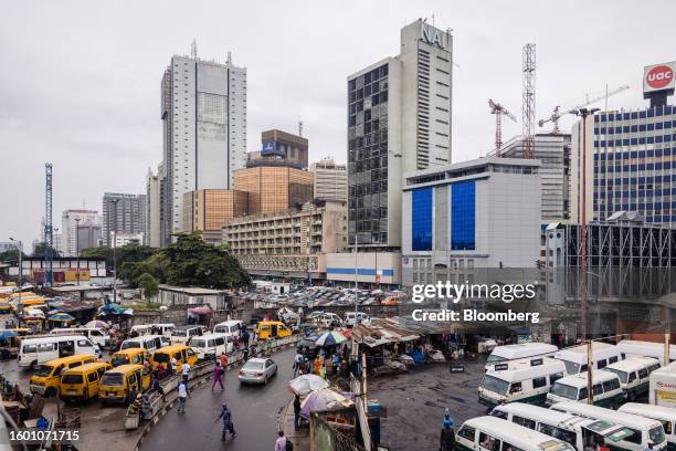 Taxi vans parked near high-rise commercial office buildings in the Central Business District of Lagos, Nigeria, on Monday, Aug. 14, 2023. Nigerian...