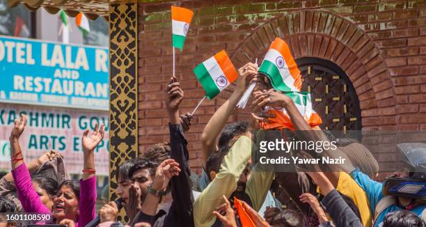 Group of Indian tourists pose with Indian national flag in the city center, during India's Independence day celebrations on August 15, 2023 in...