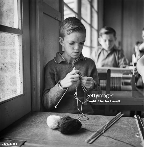 Children with learning disabilities knitting in a school classroom, circa 1957. Original Publication : Picture Post - 9255 - Defective Children -...