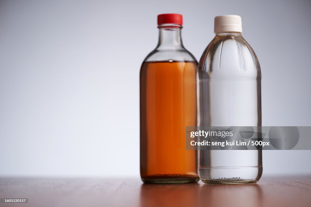 Close-up of bottles against gray background