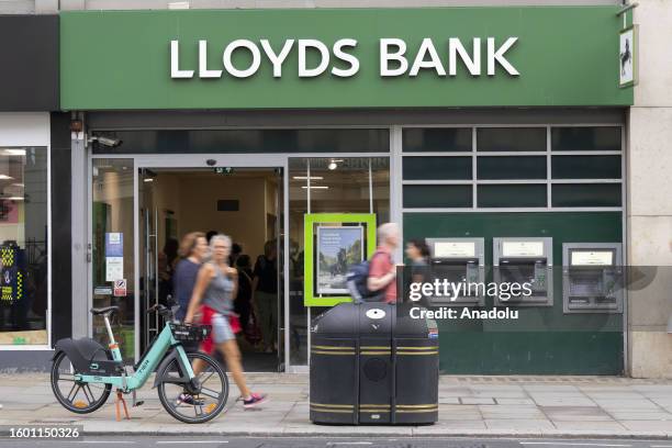 People walk pass in front of the LLoyds Bank building in London, United Kingdom on August 14, 2023. It was determined that the British economy...