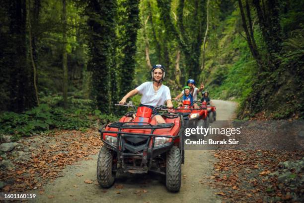 アウトドアスポーツ、家族、友情、アクティビティライフスタイルatvを使用して幸せな一日を過ごす - quadbike ストックフォトと画像