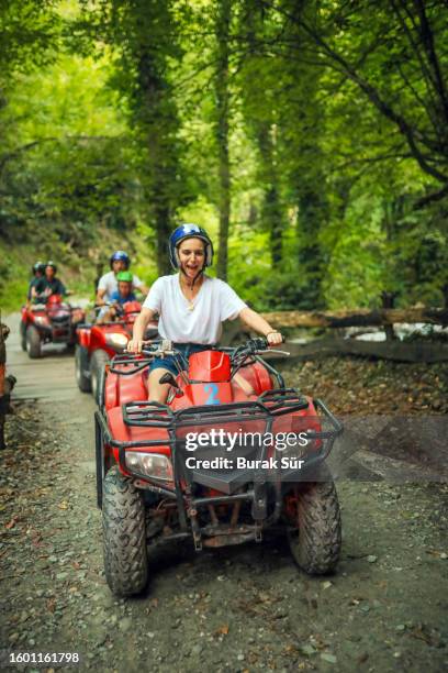 outdoor sports, family, friendship and activity lifestyle having a happy day using atv - protective sportswear stock pictures, royalty-free photos & images