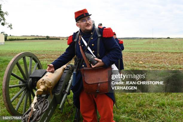 Re-enactor, in period costume of French soldiers of 2nd Regiment of Line Infantry, gives explanations during the re-enact the 1870 war and the...