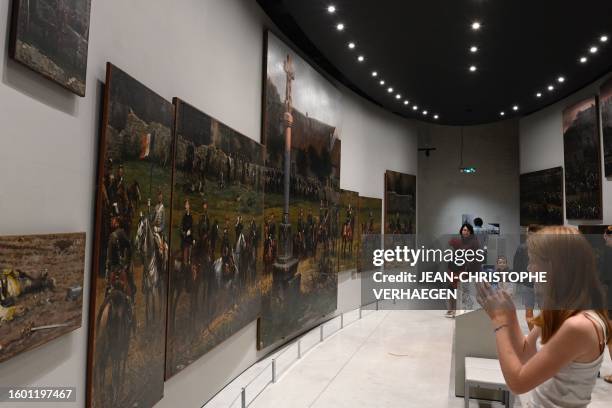 Spectators look at parts of the painting "Panorama de la bataille de Rezonville" painted by French painters Edouard Detaille and Alphonse de Neuville...