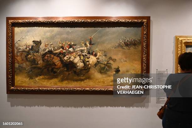 Spectator looks at the painting "La bataille de Mars-la-Tour - Vionville, charge de la brigade von Bredow" by Prussian painter Christian Sell,...