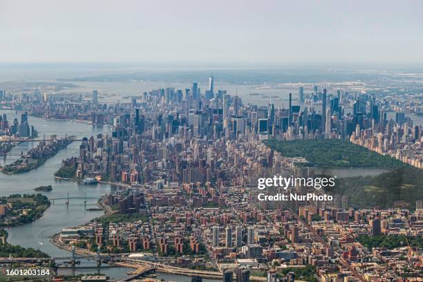 Aerial view of New York City with Central Park from an airplane window departing from LaGuardia airport. Aerial panoramic sight of the urban NYC...