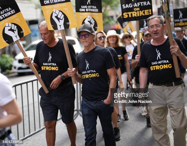 Kevin Bacon joins SAG-AFTRA members as they maintain picket lines across New York City on August 8, 2023 in New York City. Members of SAG-AFTRA and...