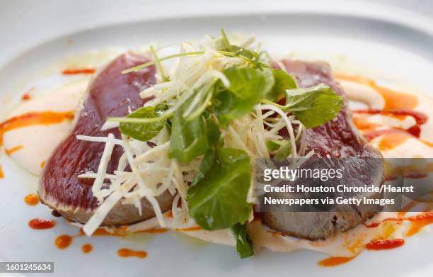 Seared ahi tuna with coconut/ginger sauce and celery root salad at Cafe Annie, in Houston.