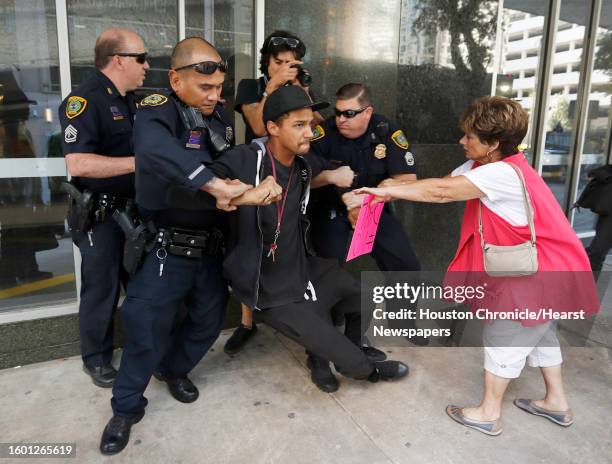 Man wrestles with Houston Police as a peaceful Dakota Access Pipeline protest was winding down, in front of 1300 Main Street Tuesday,Nov. 15, 2016 in...