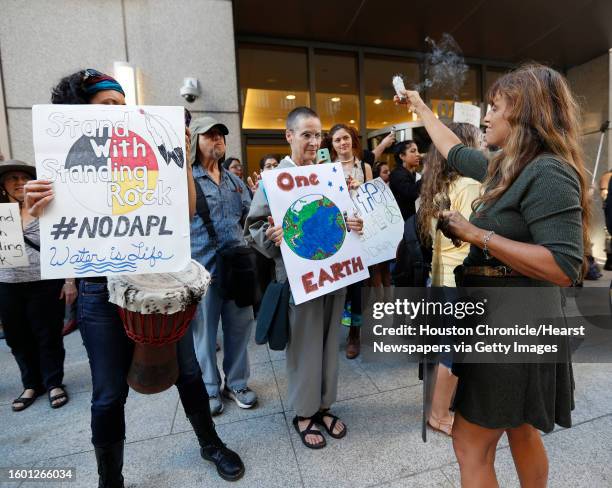 Protester with incense during a peaceful Dakota Access Pipeline protest in front of 1300 Main Street Tuesday,Nov. 15, 2016 in Houston. Two people...