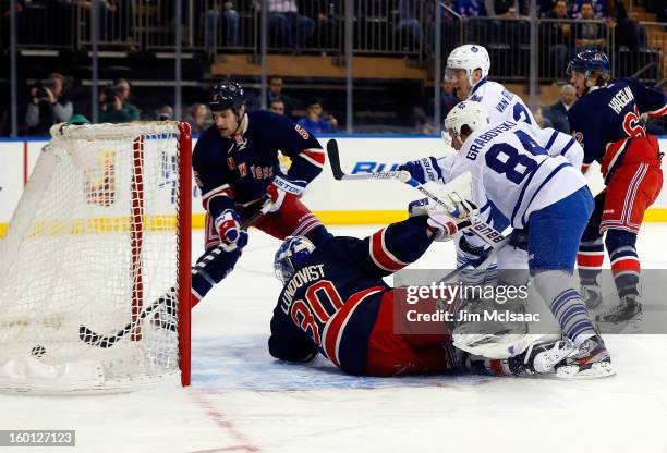 Mikhail Grabovski of the Toronto Maple Leafs scores a first period goal past Henrik Lundqvist and Dan Girardi of the New York Rangers at Madison...