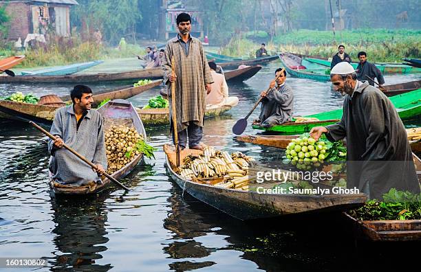 The famous floating vegetable market at Dal lake in Kashmir, only one of its kinds in India. Farmers with their vegetable laden shikaras are selling...