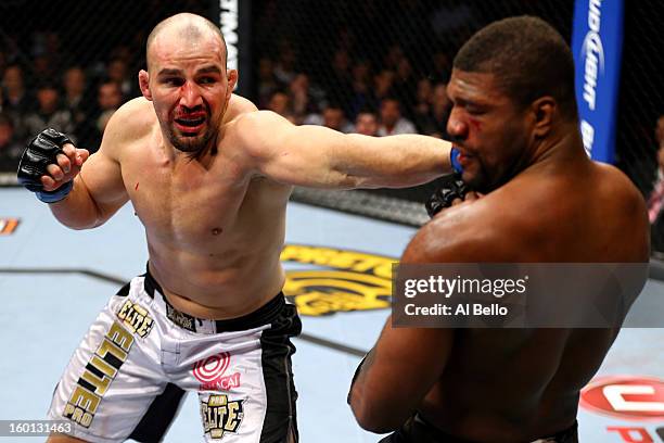 Glover Teixeira punches Rampage Jackson during their Light Heavyweight Bout part of UFC on FOX at United Center on January 26, 2013 in Chicago,...