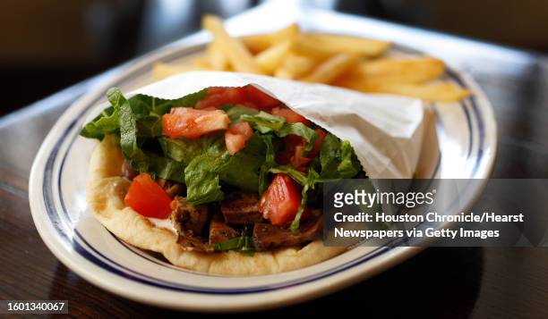 Grilled chicken pita with french fries at the new Island Grill, at 2365A Rice Blvd, in Rice Village, Monday, May 15 in Houston. Owned by Faysal...