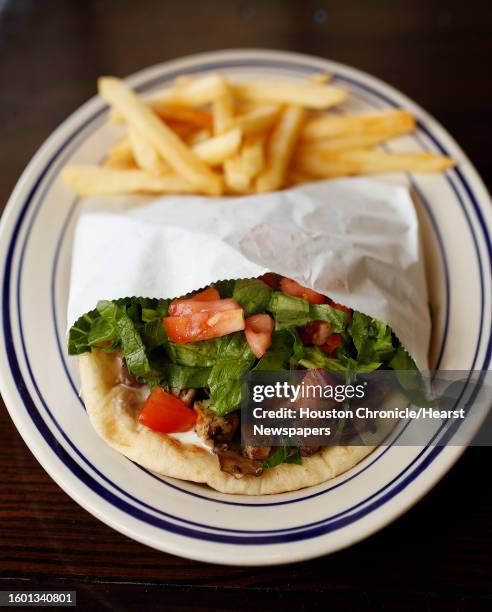 Grilled chicken pita with french fries at the new Island Grill, at 2365A Rice Blvd, in Rice Village, Monday, May 15 in Houston. Owned by Faysal...