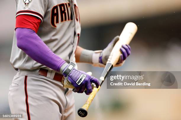 View of the Franklin batting gloves worn by Lourdes Gurriel Jr. #12 of the Arizona Diamondbacks as he sprays his bat in the on-deck circle in the...