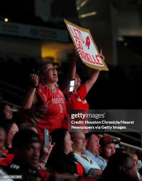 Friends and family of the seventeen women hold signs and scream as the Houston Rockets held their final tryouts for the Rockets Power Dancers, the...