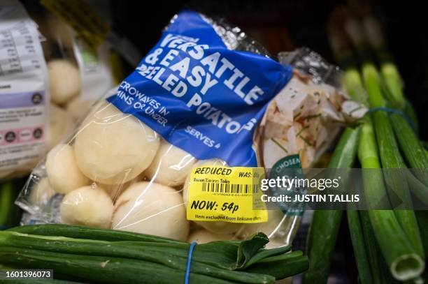 Vegetables are pictured in the reduced section at the Asda supermarket, in Aylesbury, England, on August 15, 2023. UK annual inflation stands at 7.9...