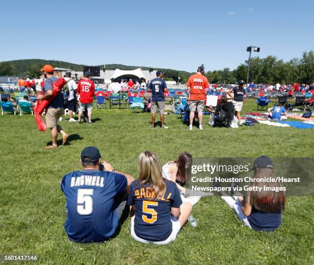 Houston Astro and Jeff Bagwell fans sit on the grass during the National Baseball Hall of Fame Induction ceremonies, Sunday, July 30 in Cooperstown.