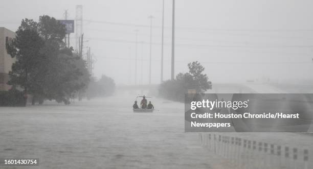 Members of the Texas Border Patrol bring their boat back to the launch site near Deerbrook Mall, on FM 1960, after currents were too rough to...