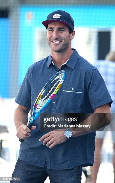 World Champion surfer Joel Parkinson plays tennis with kids from the tennis HotShots during day fourteen of the 2013 Australian Open at Melbourne...