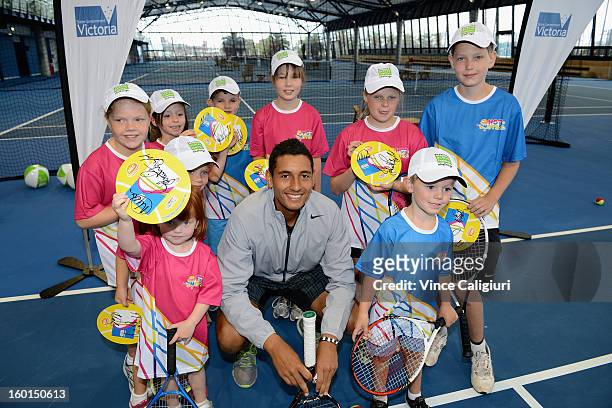 Nick Kyrgios of Australia poses with MLC Hot Shots participants at the National Tennis Centre during the launch of the Premier's Active Families...