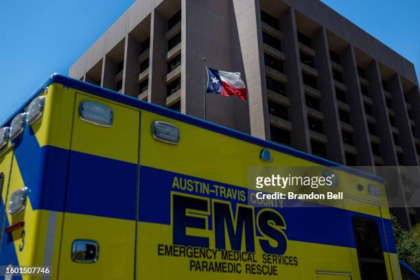 The Texas State flag is seen blowing near an EMS ambulance on August 08, 2023 in Austin, Texas. EMT were called after the patient was found passed...