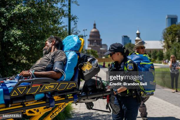 Austin-Travis County EMT assist a patient on August 08, 2023 in Austin, Texas. EMT were called after the patient was found passed out and dehydrated...