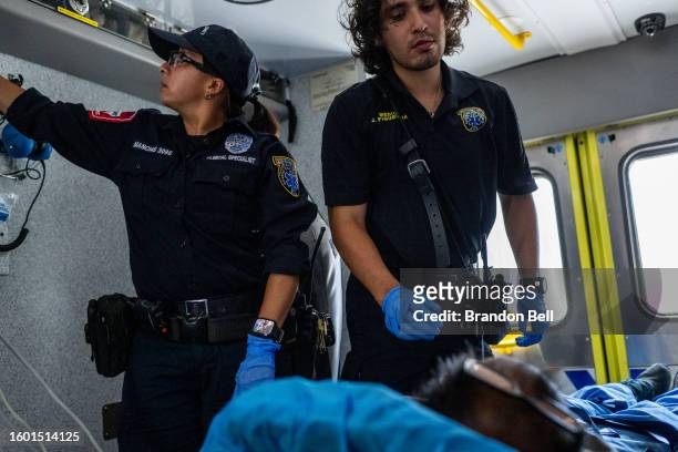 Austin Travis County medics assist a patient in an ambulance on August 08, 2023 in Austin, Texas. EMT were called after the patient was found passed...