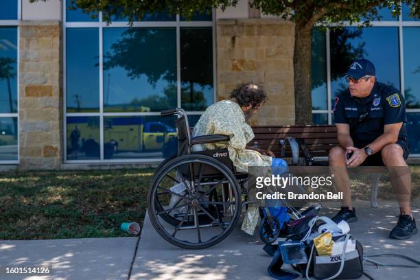 Austin-Travis County Captain C. Quiroz assists a patient dealing with heat-related symptoms on August 08, 2023 in Austin, Texas. The city of Austin...