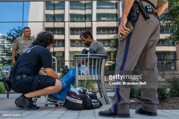 An AustinTravis County medic assists a patient on August 08, 2023 in Austin, Texas. EMT were called after the patient was found passed out and...