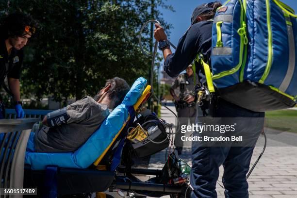 Austin-Travis County EMT assist a patient on August 08, 2023 in Austin, Texas. EMT were called after the patient was found passed out and dehydrated...