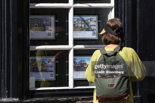 Pedestrian looks at properties advertised in the window of an estate agent in Rochester, UK, on Tuesday, Aug. 15, 2023. Grocery price inflation has...