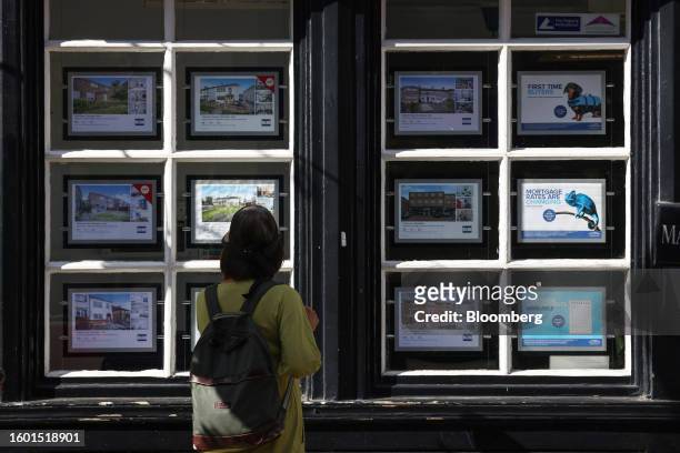 Pedestrian looks at properties advertised in the window of an estate agent in Rochester, UK, on Tuesday, Aug. 15, 2023. Grocery price inflation has...