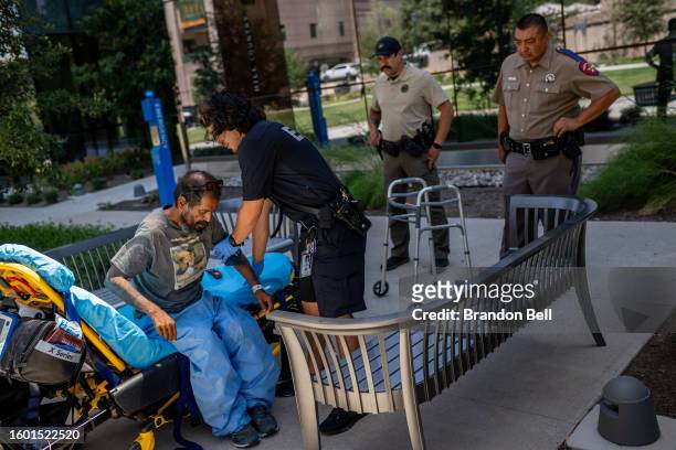 An Austin-Travis County medic assists a patient on August 08, 2023 in Austin, Texas. EMT were called after the patient was found passed out and...